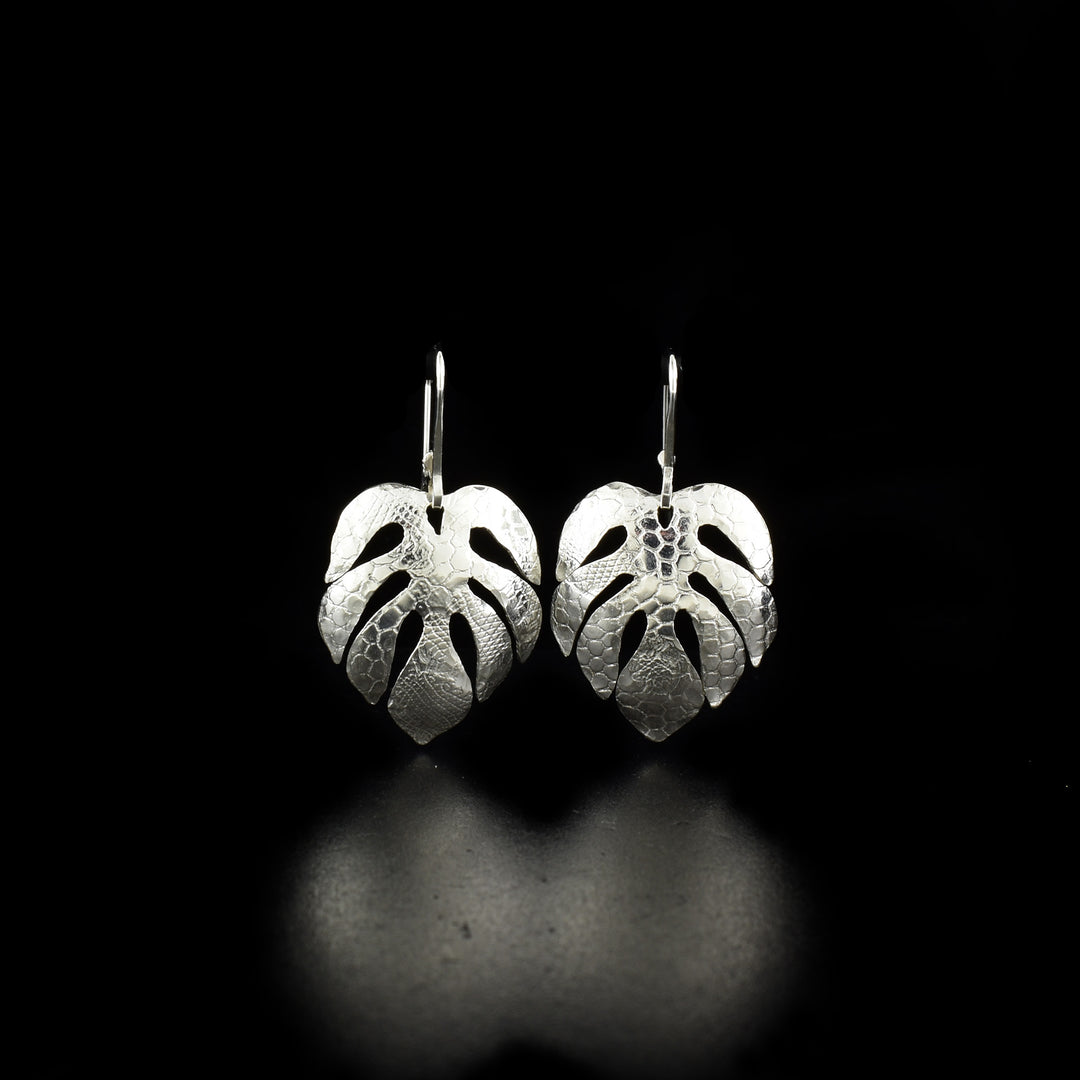 Delicate earrings handcrafted by artist Victoria Poynton. Made of sterling silver. She has used vintage French lace to emboss the design. Each earring measures 1.50" x 0.81" including hook.