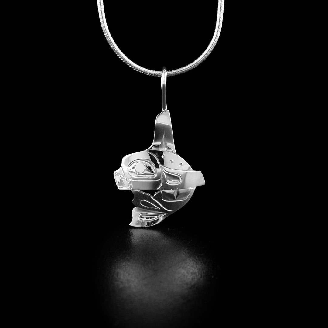 Stunning mini orca pendant hand-carved by Tlingit artist Fred Myra. Made of sterling silver. Pendant measures 1.25" x 0.75" including bail. Chain not included.