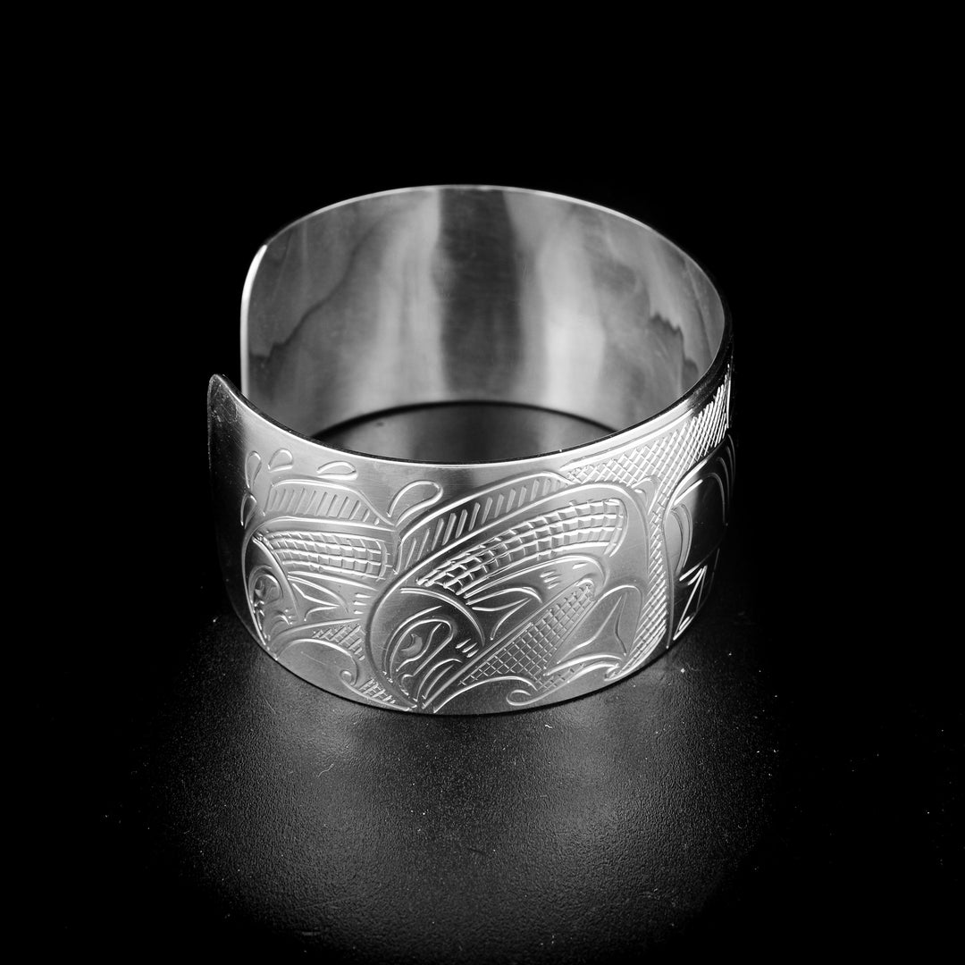 Bear and salmon cuff bracelet hand-carved by Kwakwaka'wakw artist John Lancaster. Made of sterling silver. Bracelet is 6.2" long with 0.8" gap and has width of 1".
