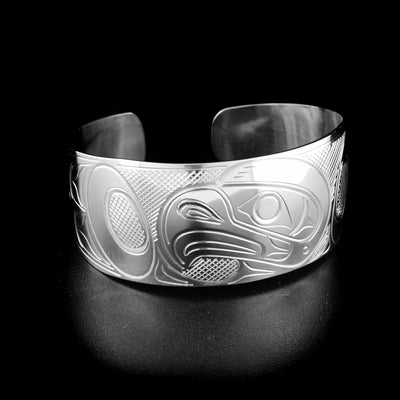 Stunning eagle bracelet hand-carved by Kwakwaka'wakw artist John Lancaster. Made of sterling silver. Bracelet is 6.1" long with 0.6" gap and has width of 1". Tapered ends.