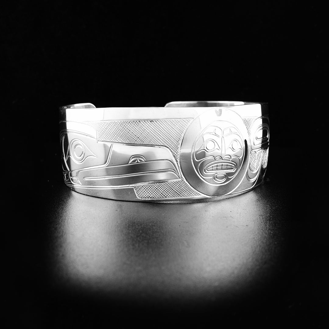 This Raven and Sun bracelet is made from sterling silver and has a single wide band with a gap in the back. There are gorgeous depictions of the Raven and the Sun carved into the band.