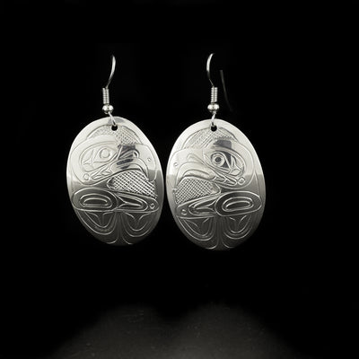 Detailed oval eagle earrings hand-carved by Kwakwaka'wakw artist Don Lancaster. Made of sterling silver. Each earring measures 2" x 1" including hook.