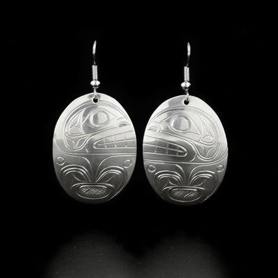 Stunning oval orca earrings hand-carved by Kwakwaka'wakw artist Don Lancaster. Made of sterling silver. Each earring measures 2" x 1" including hook.