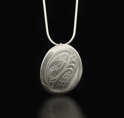 Detailed oval orca pendant hand-carved by Kwakwaka'wakw artist Don Lancaster. Made of sterling silver. Pendant measures 1.5" x 1". Hidden bail on back. Chain not included.
