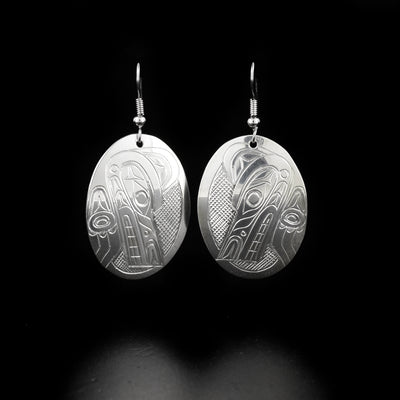Detailed oval wolf earrings hand-carved by Kwakwaka'wakw artist Don Lancaster. Made of sterling silver. Each earring measures 2" x 1" including hook.