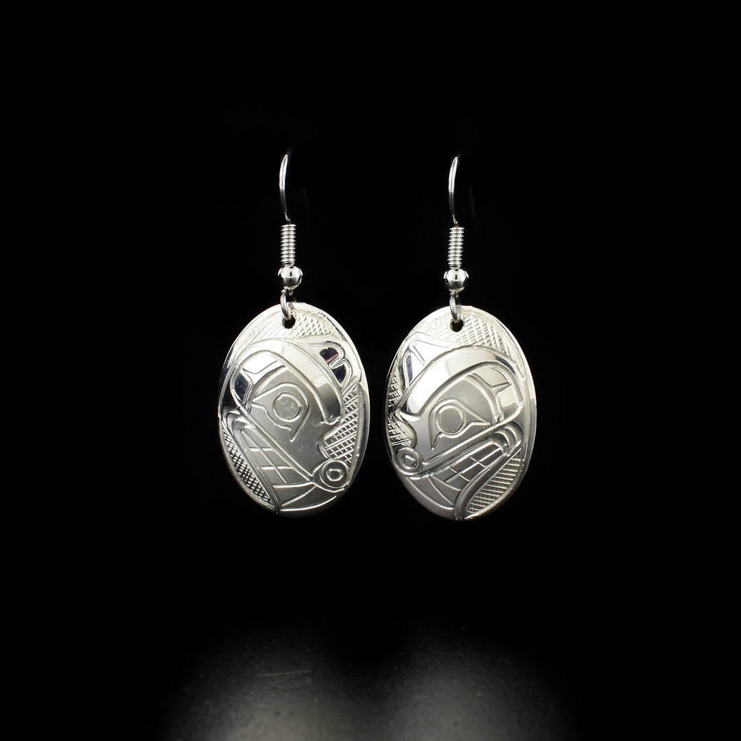 Unique wolf head earrings hand-carved by Kwakwaka'wakw artist Norman Seaweed. Made of sterling silver. Each earring measures 1.5" x 0.7" including hook.