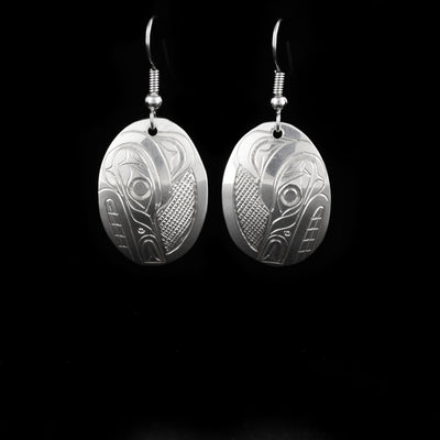 Oval wolf head earrings hand-carved by Kwakwaka'wakw artist Don Lancaster. Made of sterling silver. Each earring measures 1.5" x 0.75" including hook.