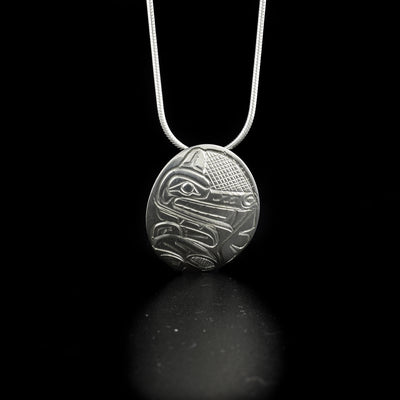 Sterling Silver Oval Wolf Pendant hand-carved by Kwakwaka'wakw artist Norman Seaweed. Pendant measures 1.2" x 0.8". Hidden bail on back. Chain not included.