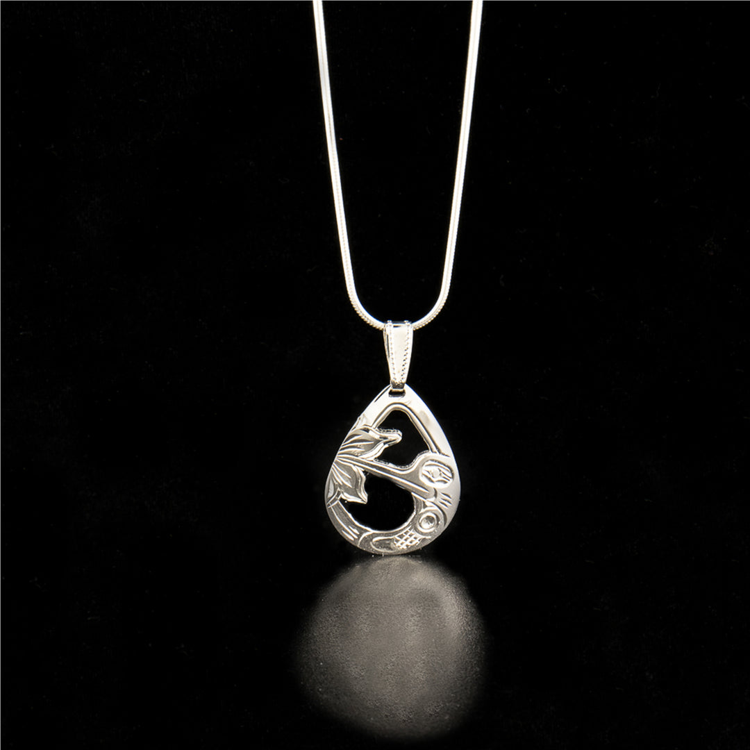 Sterling silver pear-shaped hummingbird pendant hand-carved and hand-cut by Kwakwaka'wakw artist Harold Alfred. Pendant measures 1.60" x 0.80" including bail. Chain not included.