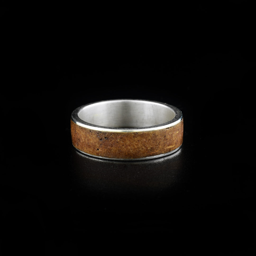 This bamboo ring is made from sterling silver, real bamboo and has a single, wide band. There is a band in the middle of the piece made from bamboo.