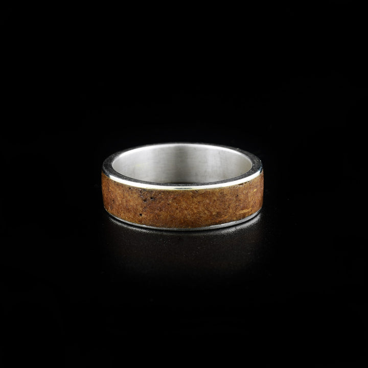 This bamboo ring is made from sterling silver, real bamboo and has a single, wide band. There is a band in the middle of the piece made from bamboo.