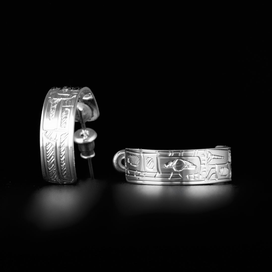 Bear hoop stud earrings hand-carved by Coast Salish artist Gilbert Pat. Made of sterling silver. Each earring has width of 0.25" and diameter of 0.75".
