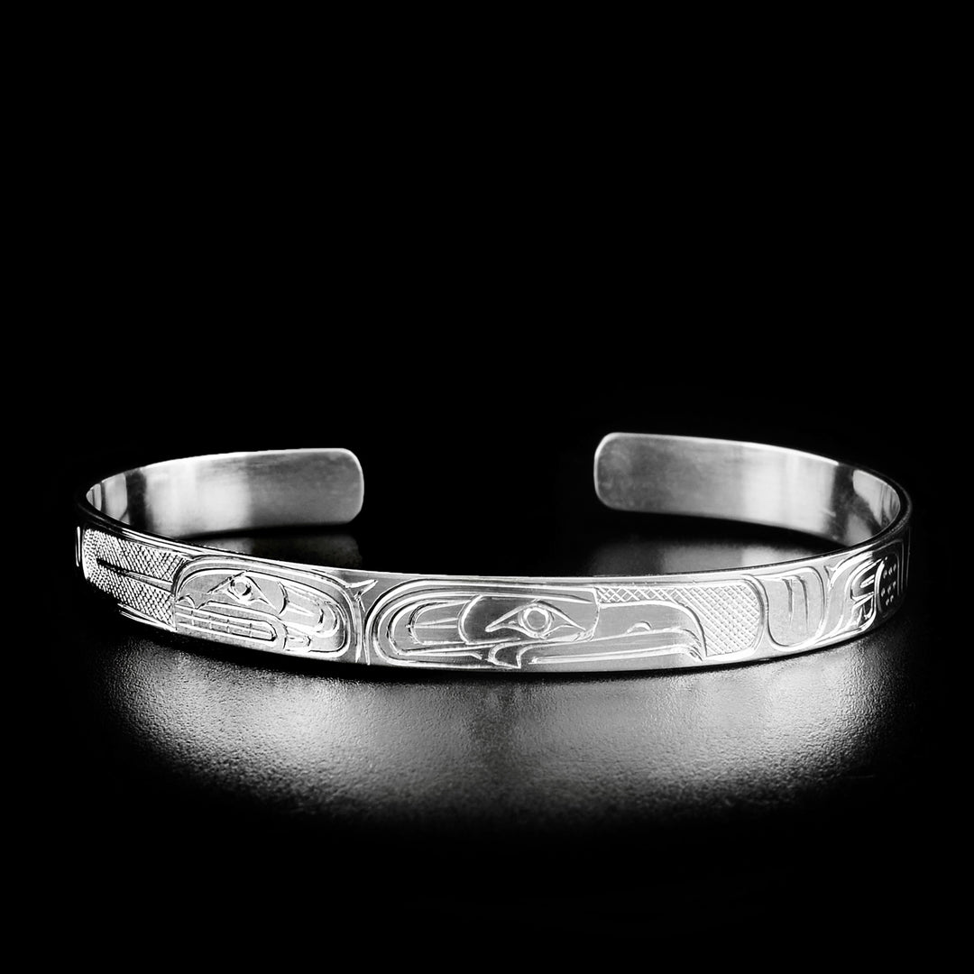 Second style of bracelet. The head of the eagle is facing away from the head of the orca on the left.