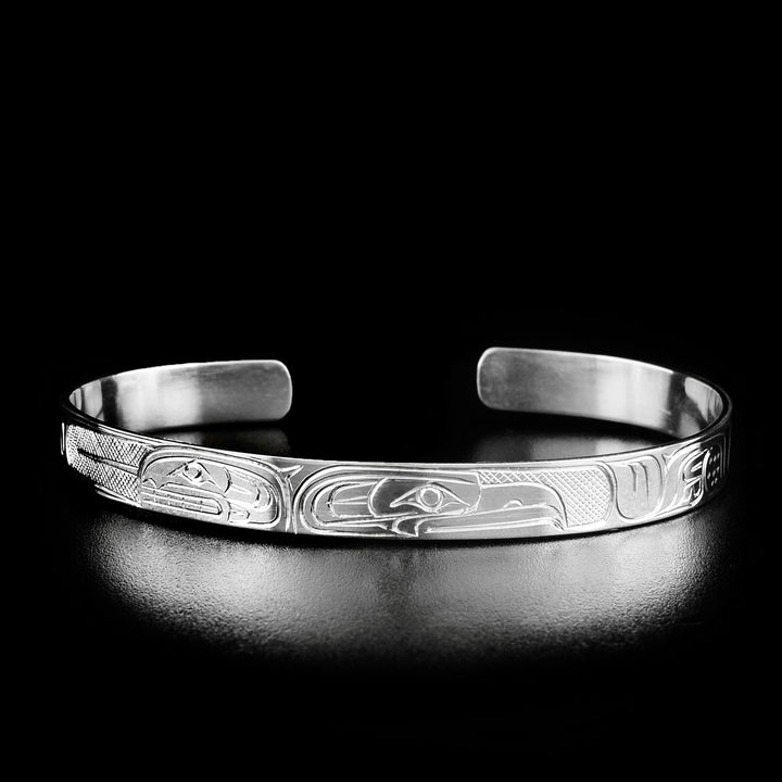Second style of bracelet. The head of the eagle is facing away from the head of the orca on the left.
