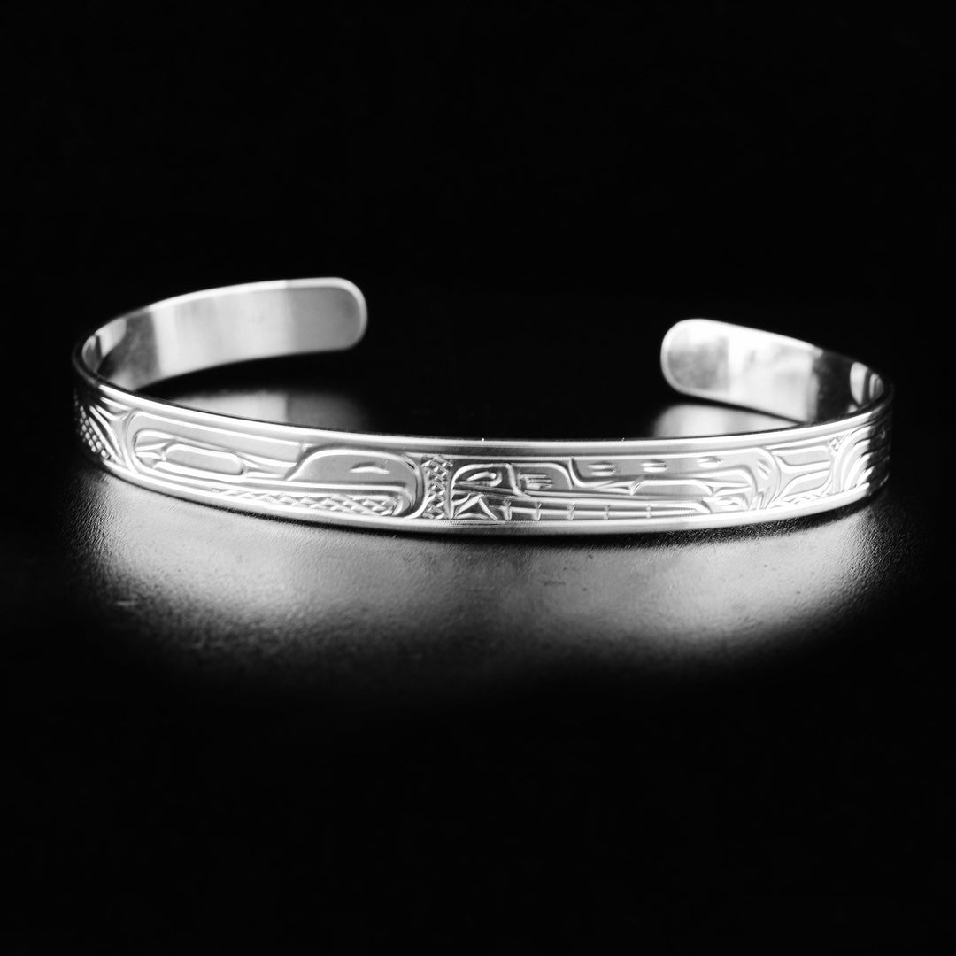 This Bear and Thunderbird bracelet is made form sterling silver and has a thin band with a gap in the back. There are gorgeous depictions of the Thunderbird and the Bear that have been carved into the surface of the band.