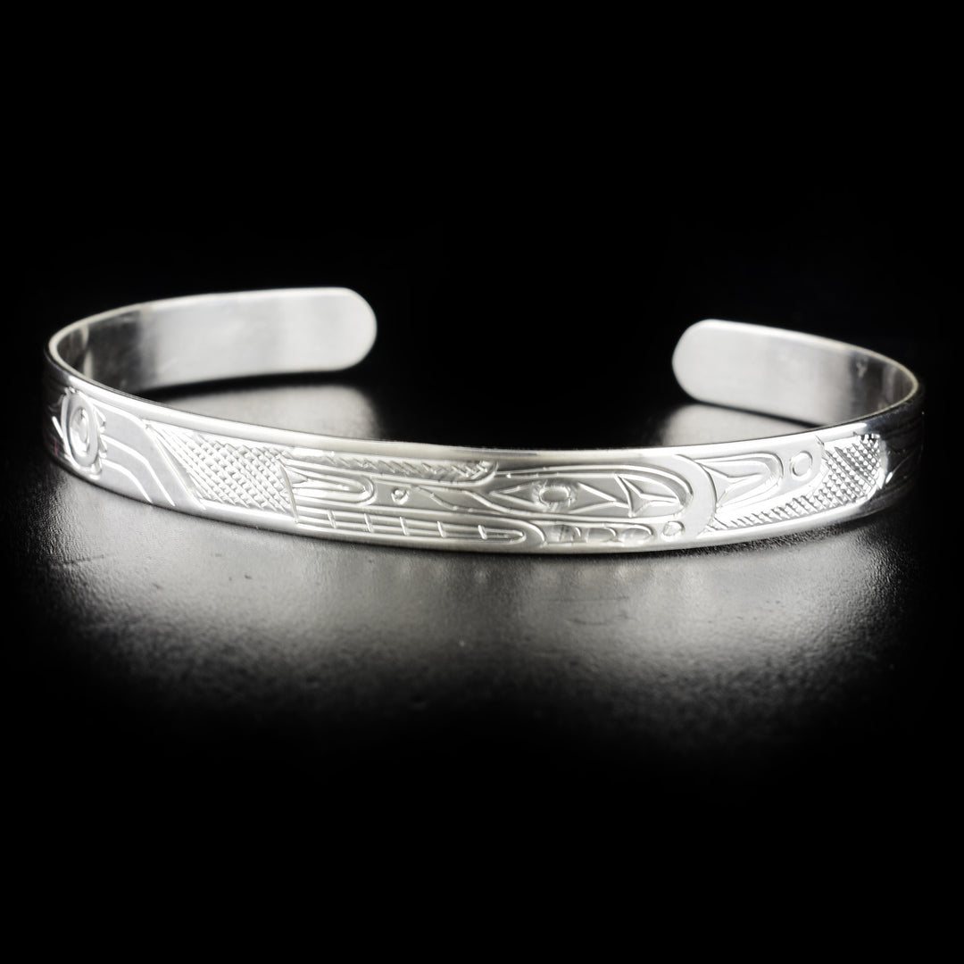Stunning wolf bracelet hand-carved by Kwakwaka'wakw artist Don Lancaster. Made of sterling silver. Bracelet is 6.15" long with 1" gap and has width of 0.25".
