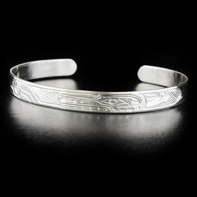 Stunning wolf bracelet hand-carved by Kwakwaka'wakw artist Don Lancaster. Made of sterling silver. Bracelet is 6.15" long with 1" gap and has width of 0.25".