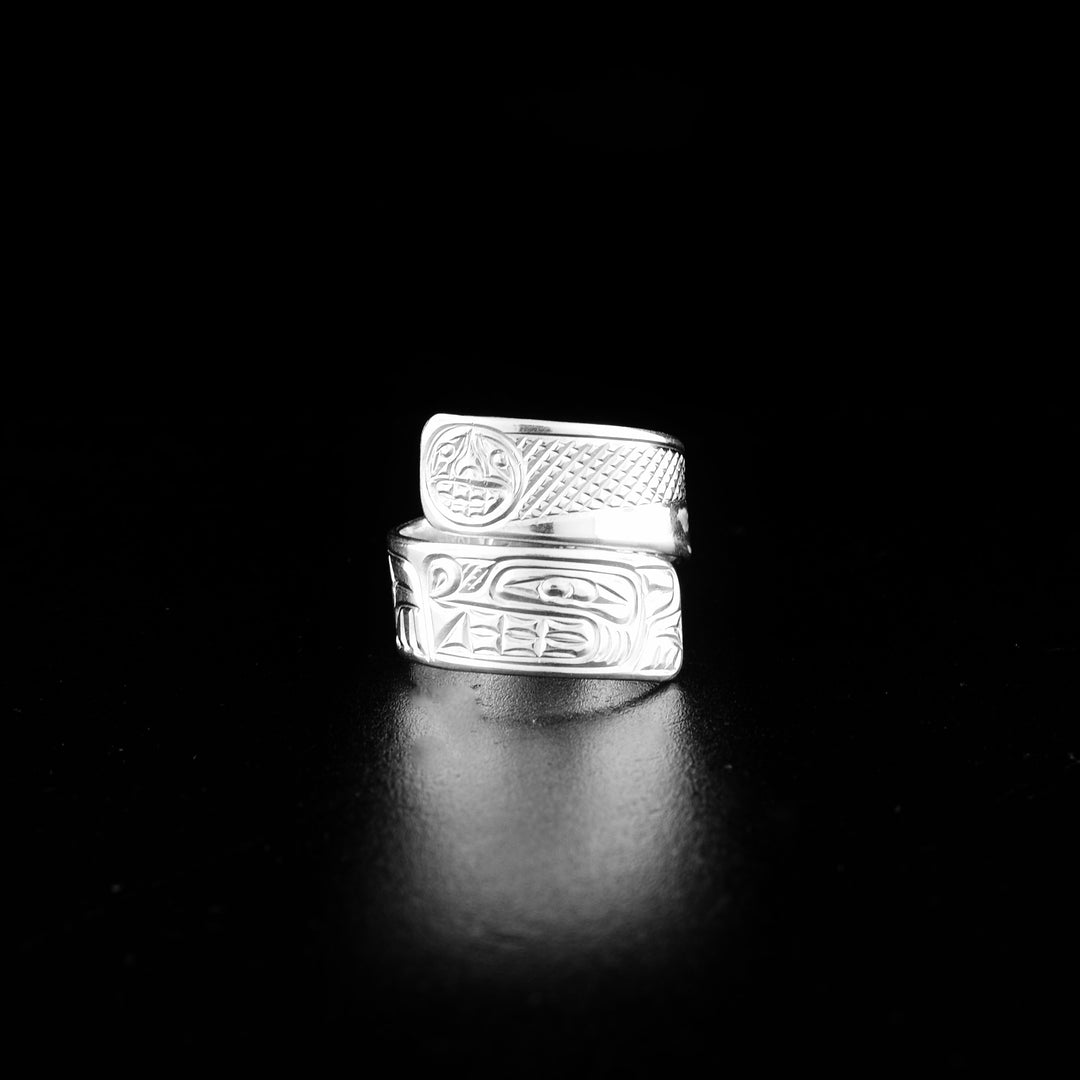 Sterling silver wolf wrap ring hand-carved by Coast Salish and Cree artist Richard Lang. Ring depicts a wolf below the moon. Band is 0.25" wide, with the flexible wrap design giving the ring a comfortable fit. Size 6.5.