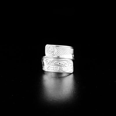 Sterling silver wolf wrap ring hand-carved by Coast Salish and Cree artist Richard Lang. Ring depicts a wolf below the moon. Band is 0.25" wide, with the flexible wrap design giving the ring a comfortable fit. Size 6.5.