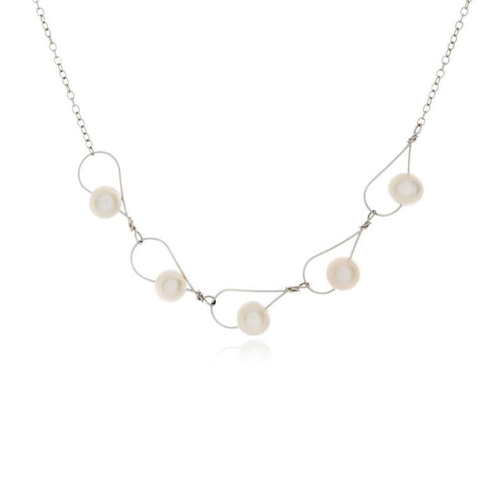 This pearl chain necklace has a dainty chain with large, teardrop shaped chain links on the bottom section of the necklace. The chains are made from sterling silver and there are fresh water pearl beads featured on the large, silver links.