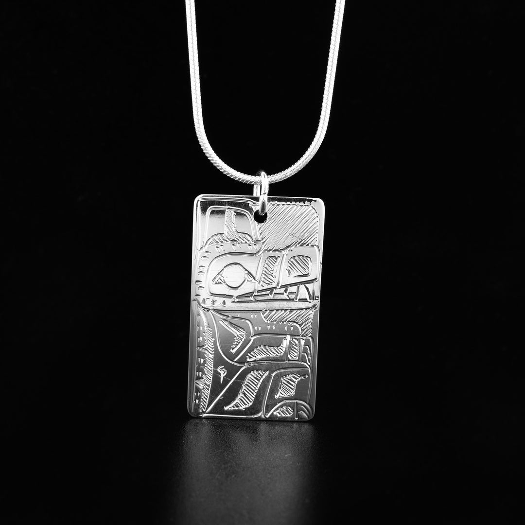This gorgeous Raven and Bear pendant is made form sterling silver and has a long, rectangular shape. There are brilliant depictions of the Bear and the Raven carved into either side of this double sided pendant.