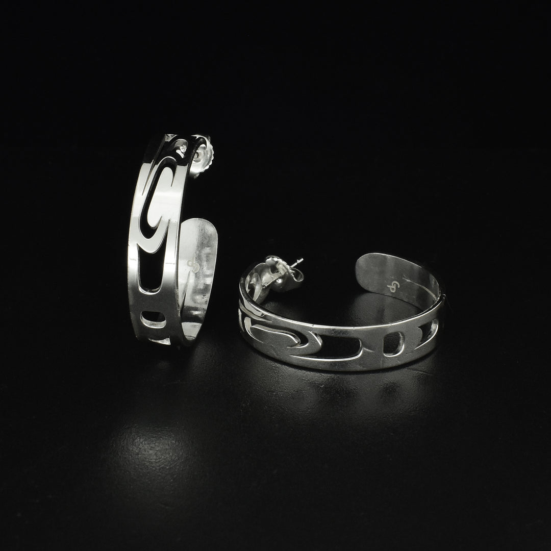 Unique raven hoop stud earrings by Tahltan artist Grant Pauls. Made of sterling silver. Each earring has diameter of 1.13" and width of 0.25".