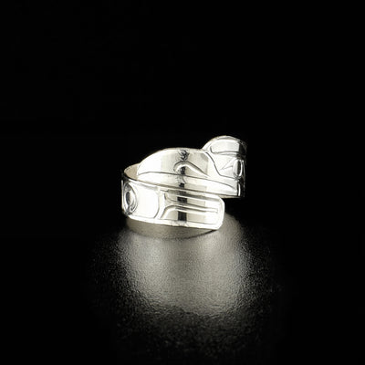 Ring wraps around once, with head of raven at the top. Carved designs on the rest of the ring depict the raven’s wing.