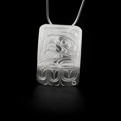 Rectangular thunderbird pendant hand-carved by Kwakwaka'wakw artist Don Lancaster. Made of sterling silver. Pendant measures 1.5" x 1". Hidden bail on back. Chain not included.