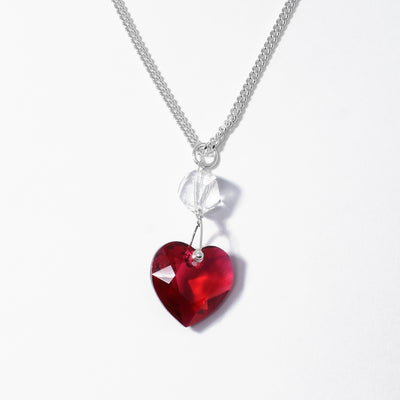 Stunning Sterling Silver Red Swarovski Crystal Heart Pendant handcrafted by artist Debra Nelson. Made of sterling silver and Swarovski Crystal. Pendant measures 1.38" x 0.56" including bail. Chain is not included.