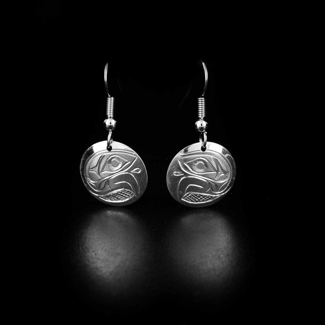 These dangling Eagle earrings are made from sterling silver and has circular hangs. There are depictions of the Eagle carved into the surface of the hangs.