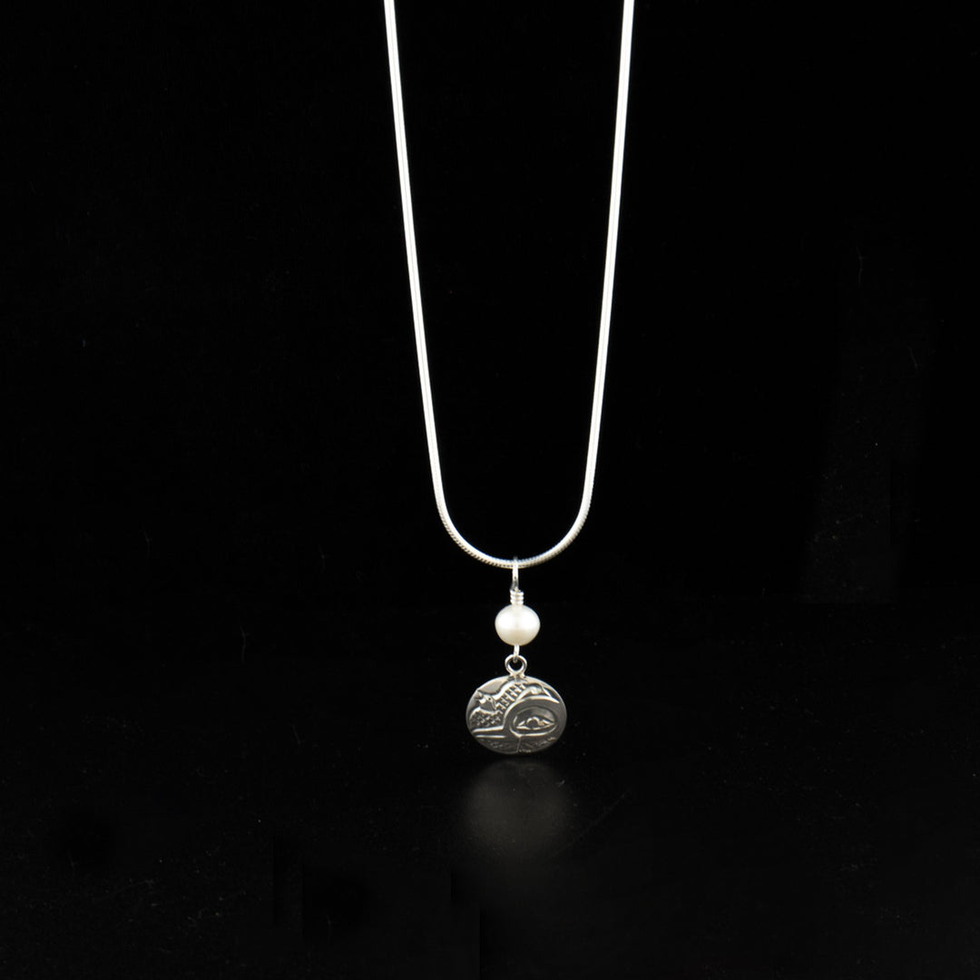Sterling silver round hummingbird pendant with freshwater pearl hand-carved by Kwakwaka'wakw artist Carrie Matilpi. Pendant measures 1.25" x 0.56" including bail. Chain not included.