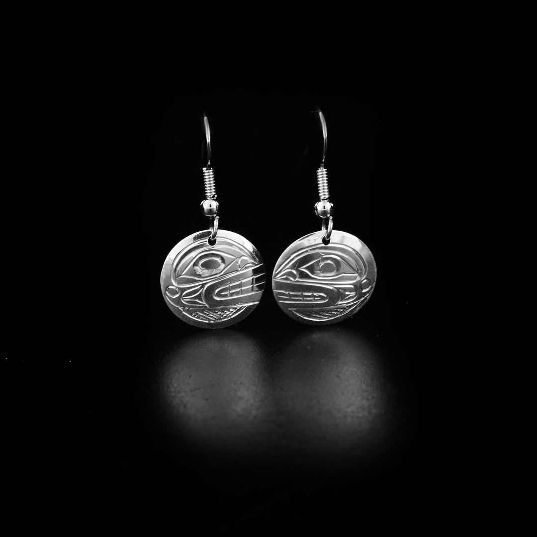 These circle dangle earrings are made from sterling silver and the hangs are circle shaped. There are depictions of the Orca carved into the surface of the hangs.