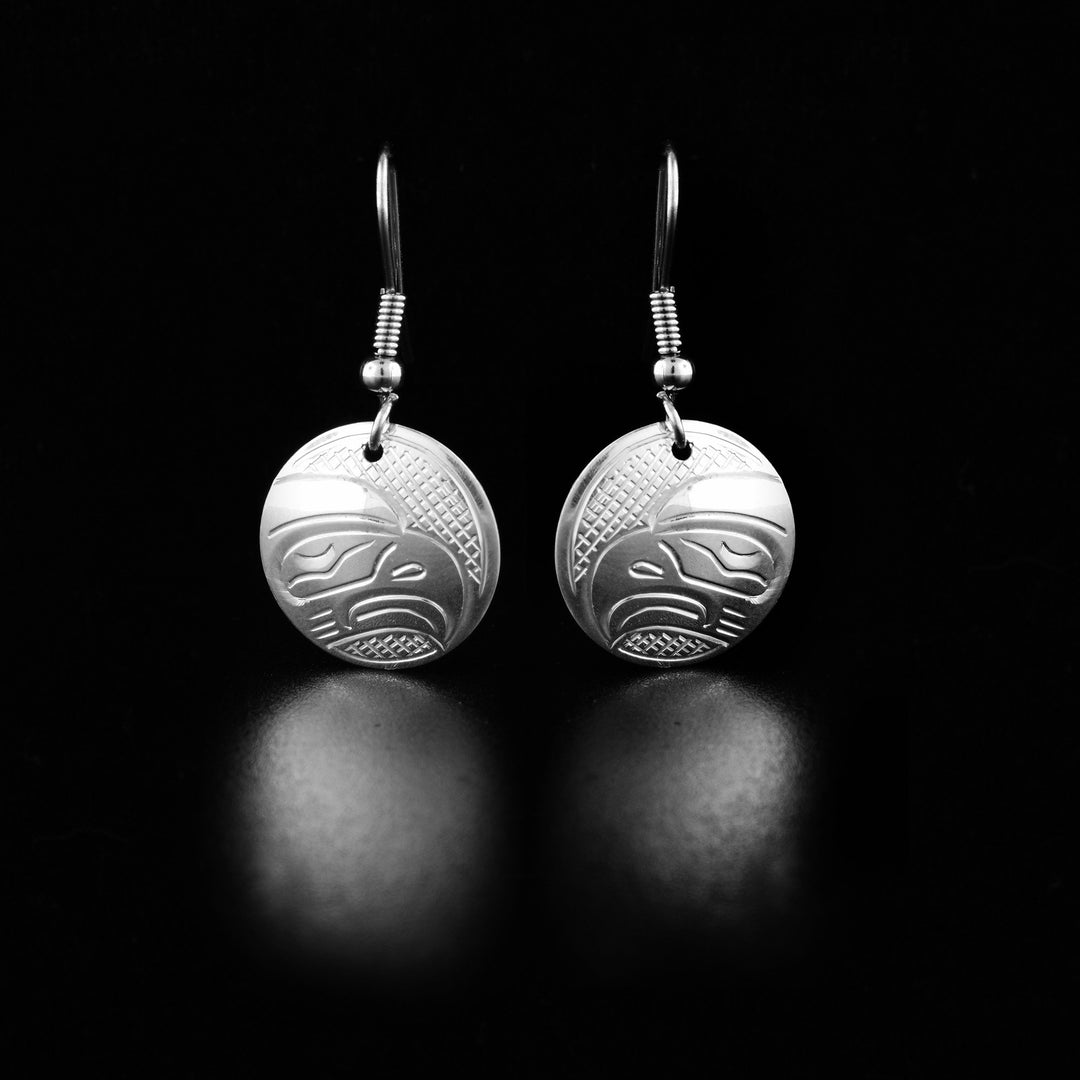 These dangling Eagle earrings are made from sterling silver and has small, circle shaped hangs. There are depictions of the Eagle carved into the surface of the hangs.