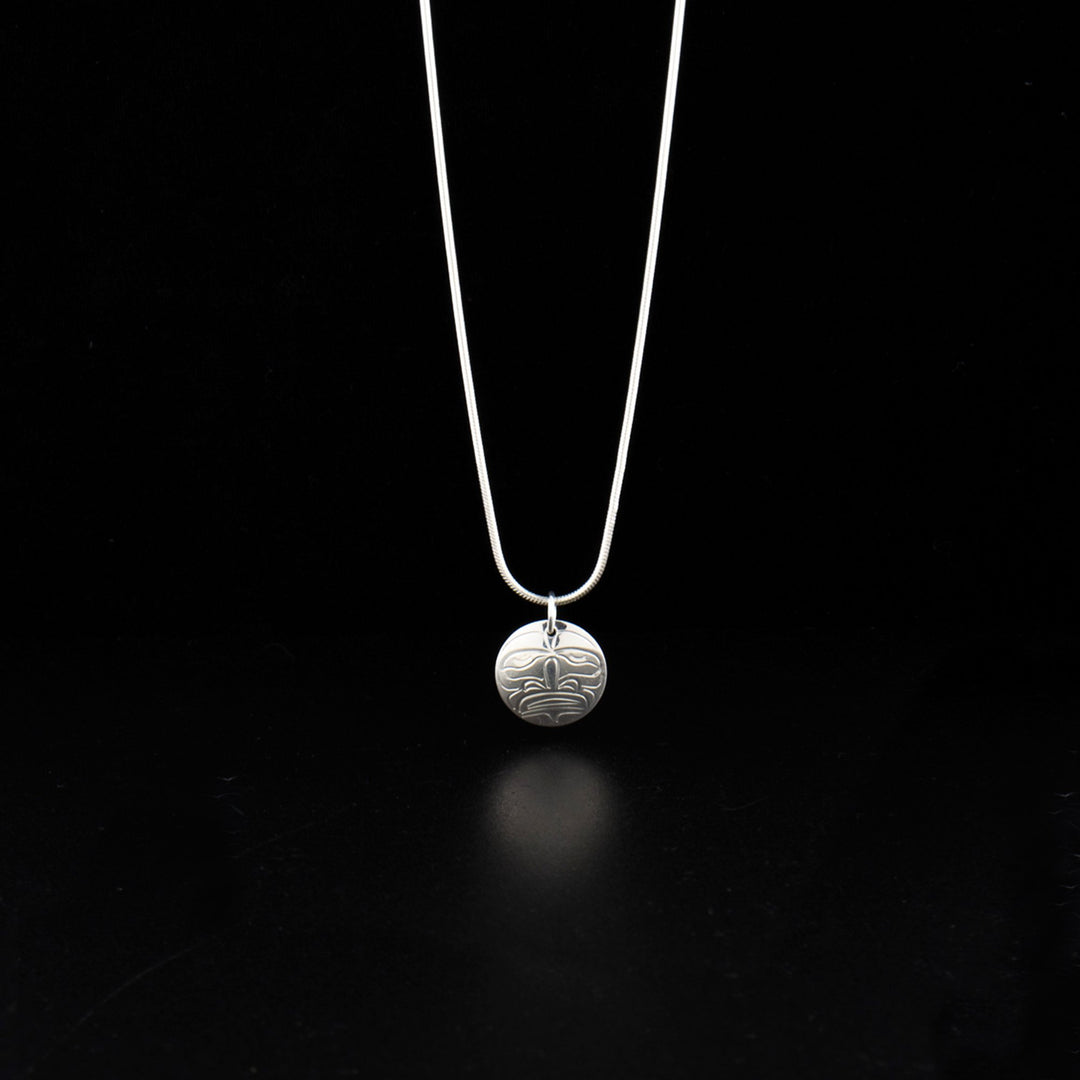 Sterling silver small moon charm pendant hand-carved by Kwakwaka'wakw artist John Lancaster. Pendant measures 0.75" x 0.63" including bail. Chain not included.