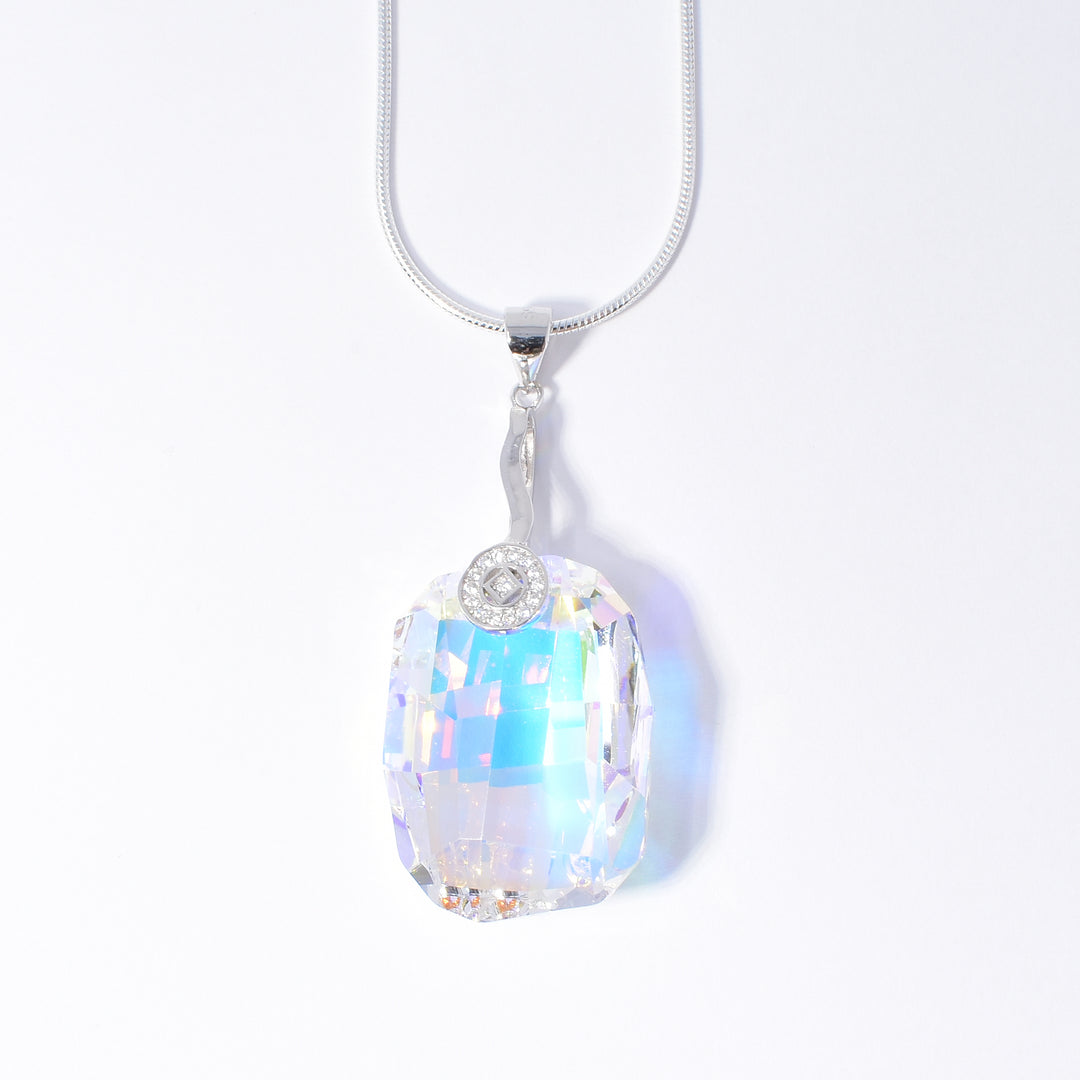 Sterling Silver Swarovski Crystal Large Graphic Pendant handcrafted by artist Debra Nelson. Made of cubic zirconia, Aurora Borealis Swarovski Crystal and sterling silver. Pendant measures 1.88" x 0.81" including bail. Chain is not included.