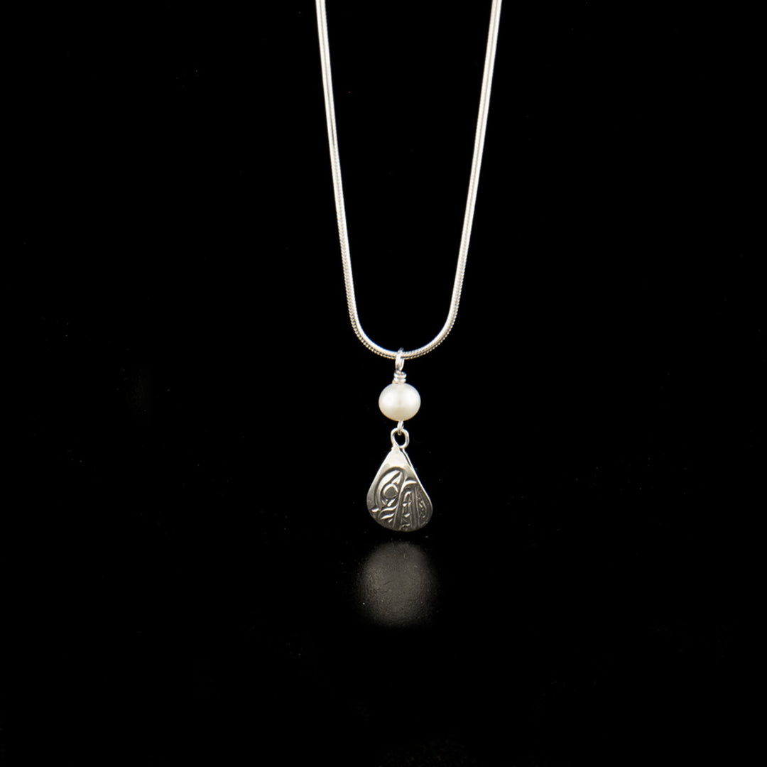 Sterling silver teardrop bear pendant with pearl hand-carved by Kwakwaka'wakw artist Carrie Matilpi. Pendant measures 1.13" x 0.50" including bail. Chain not included.