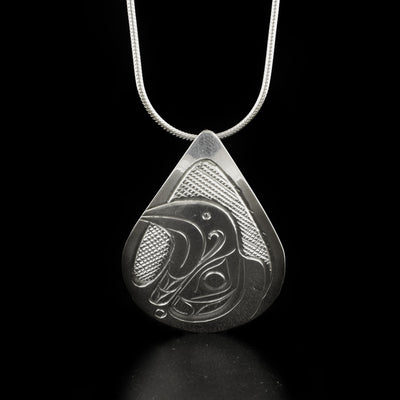 Detailed teardrop eagle head pendant hand-carved by Kwakwaka'wakw artist Don Lancaster. Made of sterling silver. Pendant measures 1.5" x 1". Hidden bail on back. Chain not included.