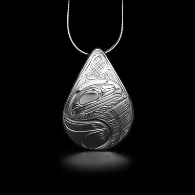 Unique teardrop raven pendant hand-carved by Kwakwaka'wakw artist Victoria Harper. Made of sterling silver. Pendant measures 1.40" x 1.15". Hidden bail on back. Chain not included.