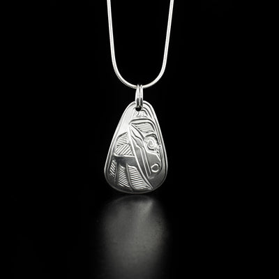 Teardrop raven pendant hand-carved by Heiltsuk artist Ivan Wilson. Made of sterling silver. Pendant measures 1.60" x 0.90" including bail. Chain not included.