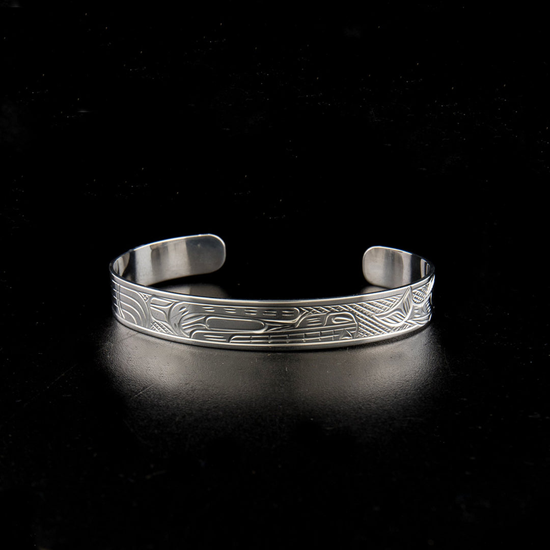 Sterling silver bear and salmon bracelet hand-carved by Kwakwaka'wakw artist Victoria Harper. 6.25" long with 1.25" gap. 0.38" wide.