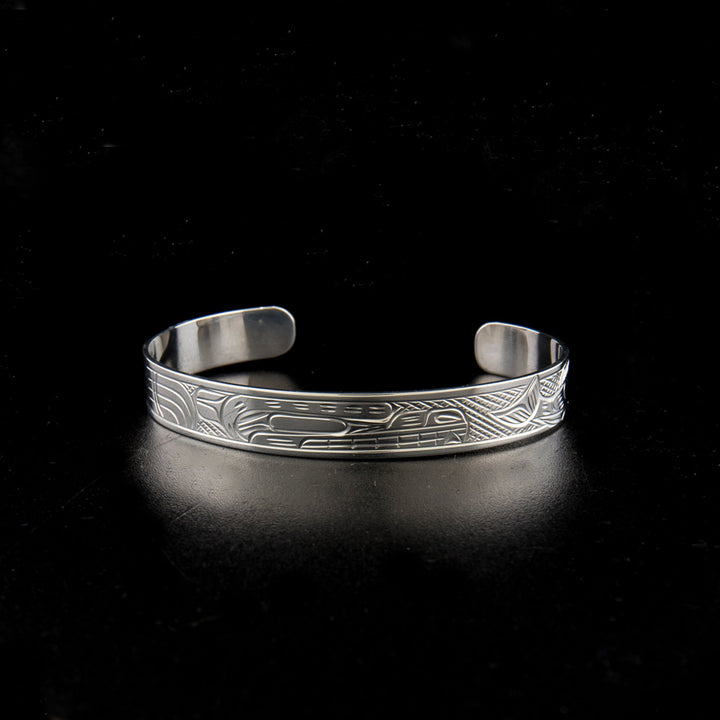 Sterling silver bear and salmon bracelet hand-carved by Kwakwaka'wakw artist Victoria Harper. 6.25" long with 1.25" gap. 0.38" wide.