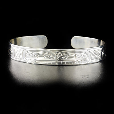 Stunning double orca bracelet hand-carved by Kwakwaka'wakw artist Don Lancaster. Made of sterling silver. Bracelet is 6.65" long with 0.70" gap and has width of 0.50".