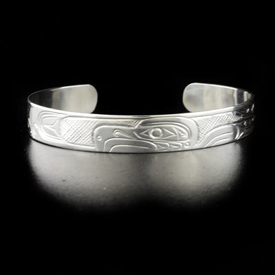Eagle bracelet hand-carved by Kwakwaka'wakw artist Don Lancaster. Made of sterling silver. Bracelet is 6.20" long with 1" gap and has width of 0.38".