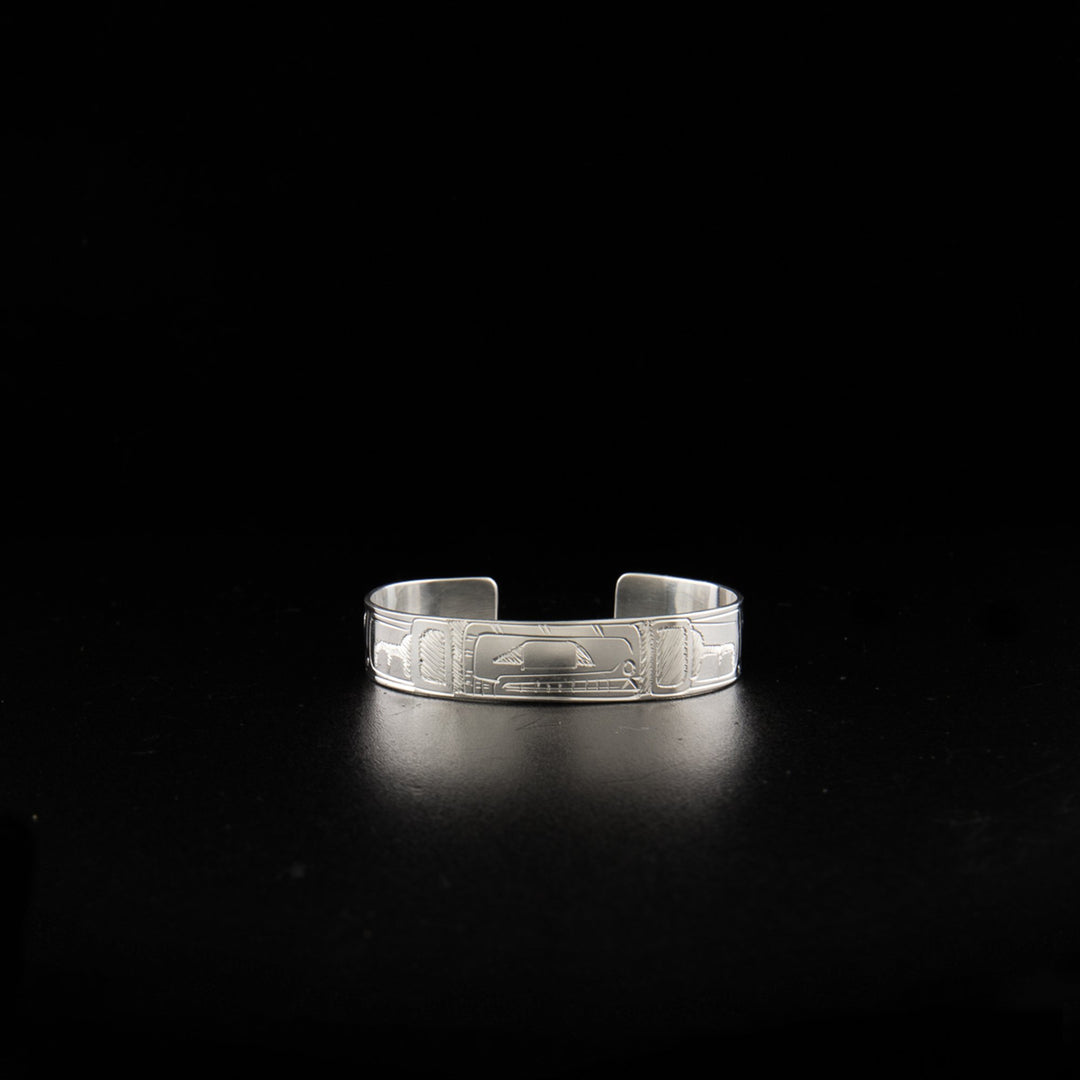 Sterling silver orca baby bracelet hand-carved by Coast Salish artist Gilbert Pat. 4.13" long with 0.63" gap. 0.38" wide.