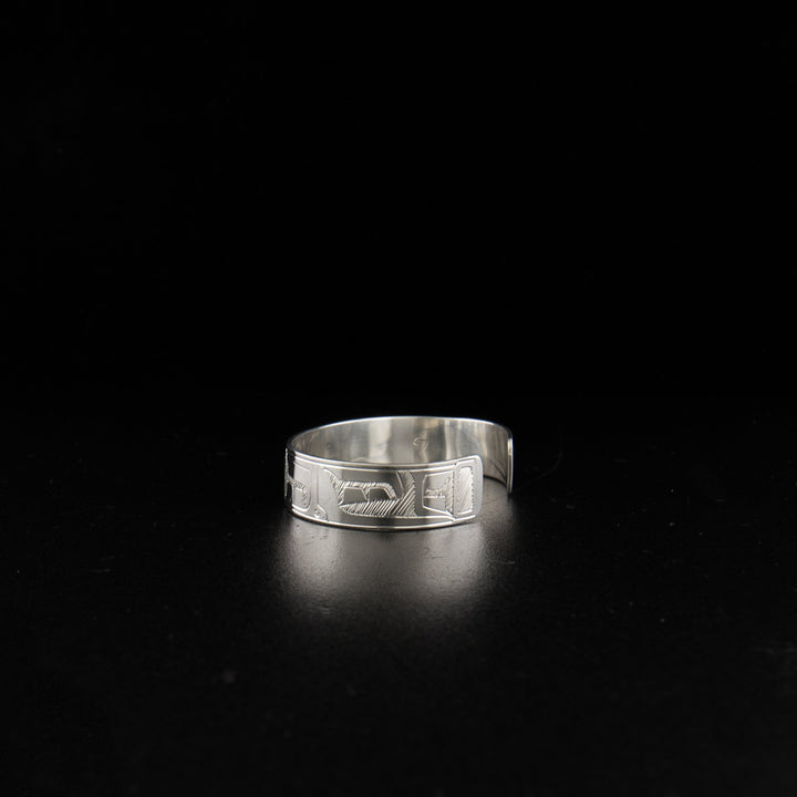 Sterling silver orca baby bracelet hand-carved by Coast Salish artist Gilbert Pat. 4.13" long with 0.63" gap. 0.38" wide.