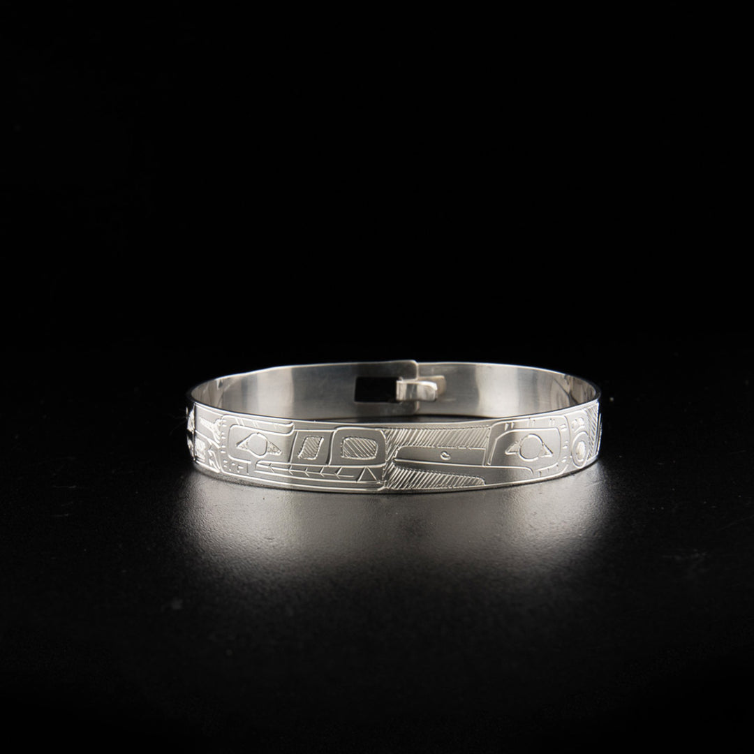 Sterling silver wolf and hummingbird clasp bracelet hand-carved by Coast Salish artist Gilbert Pat.