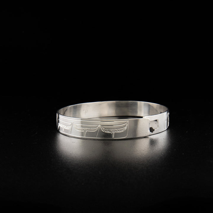 Sterling silver wolf and hummingbird clasp bracelet hand-carved by Coast Salish artist Gilbert Pat.