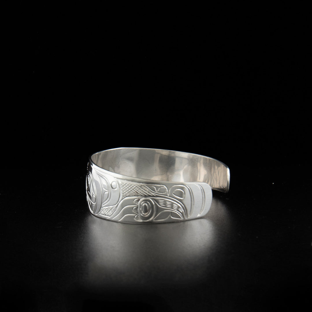 Sterling silver bear and wolf bracelet hand-carved by Kwakwaka'wakw artist Don Lancaster. 6.25" long with 0.81" gap. 0.75" wide with tapered ends.