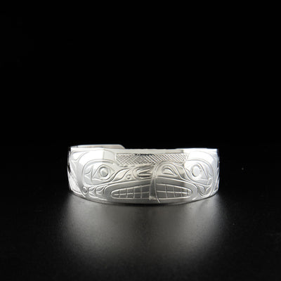 Sterling silver bear and wolf bracelet hand-carved by Kwakwaka'wakw artist Don Lancaster. 6.25" long with 0.81" gap. 0.75" wide with tapered ends.