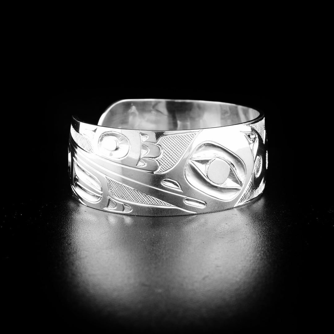 Double hummingbird bracelet hand-carved by indigenous artist Ivan Thomas. Made of sterling silver. Bracelet is 6.3" long with a 0.6" gap and has width of 0.75".
